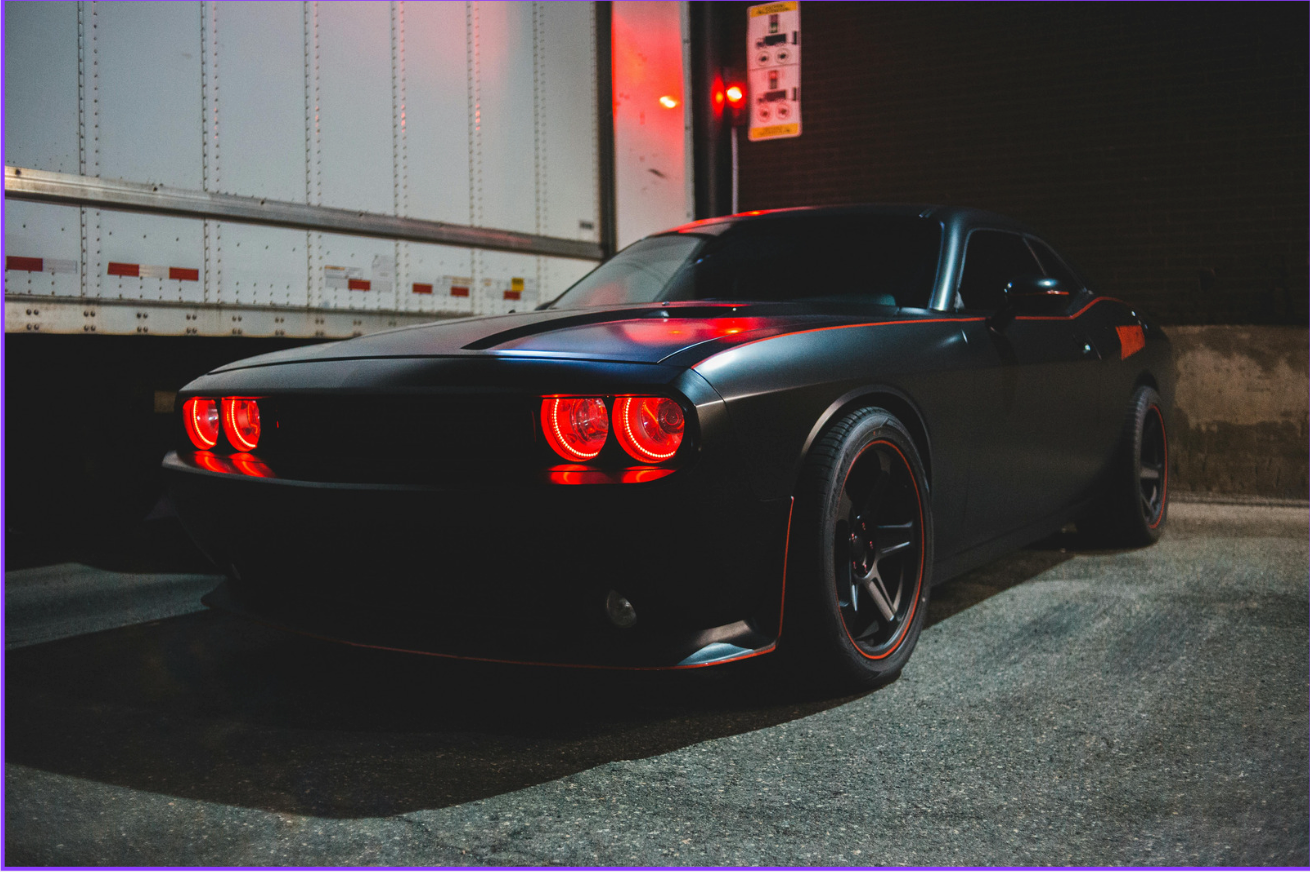 Black performance car with dramatic red accents